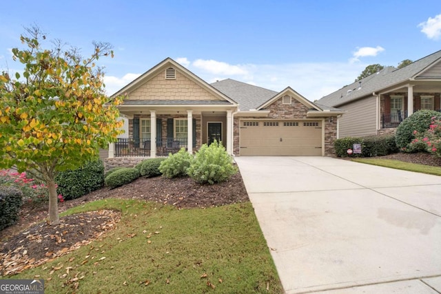 craftsman-style home with an attached garage, stone siding, a porch, driveway, and a front lawn
