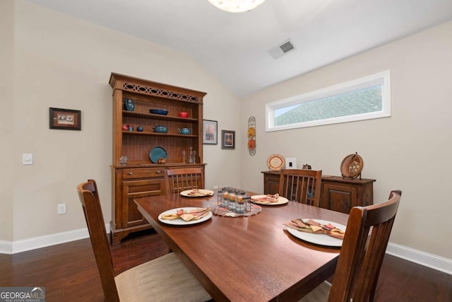 dining space featuring baseboards, dark wood-type flooring, and vaulted ceiling