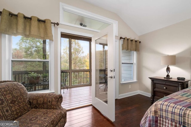 bedroom with dark wood-style flooring, lofted ceiling, multiple windows, and baseboards