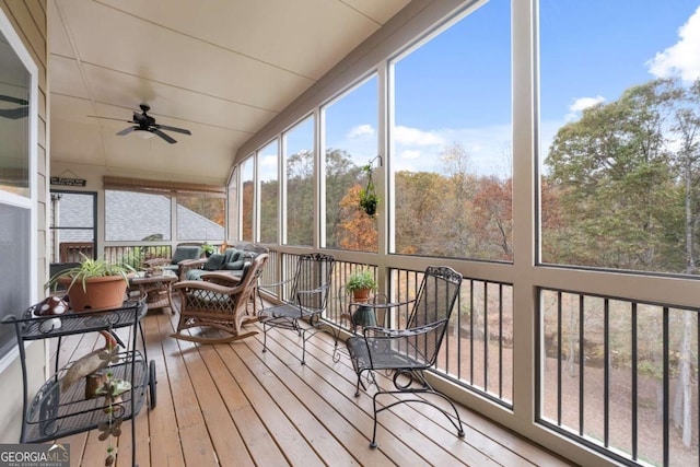 sunroom / solarium featuring ceiling fan and an outdoor hangout area