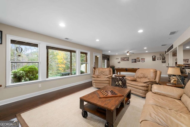 living room with wood finished floors, recessed lighting, a ceiling fan, and baseboards