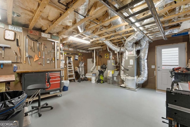 below grade area featuring a workshop area, gas water heater, and heating unit
