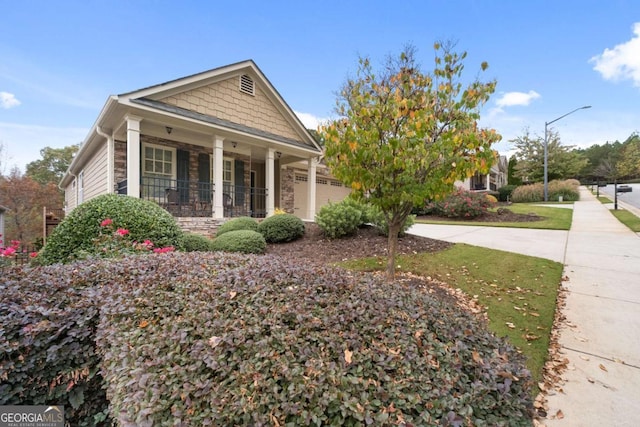 view of front of house with stone siding and a porch