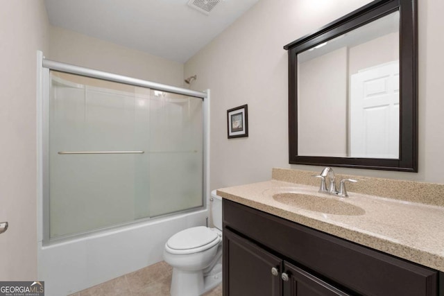 full bath with toilet, vanity, shower / bath combination with glass door, and tile patterned floors