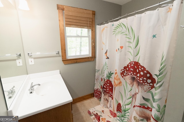 bathroom featuring vanity, tile patterned flooring, baseboards, and a shower with shower curtain
