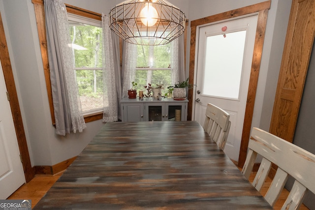 doorway to outside with plenty of natural light, light wood-type flooring, and baseboards