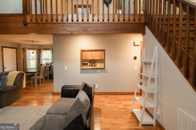 living area with light wood finished floors and baseboards