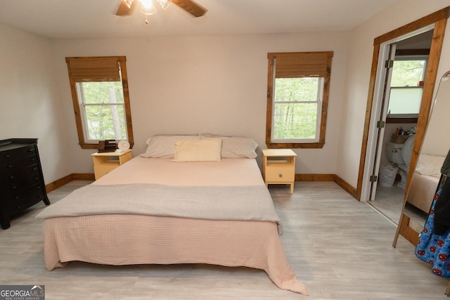 bedroom with baseboards, light wood-type flooring, and ceiling fan