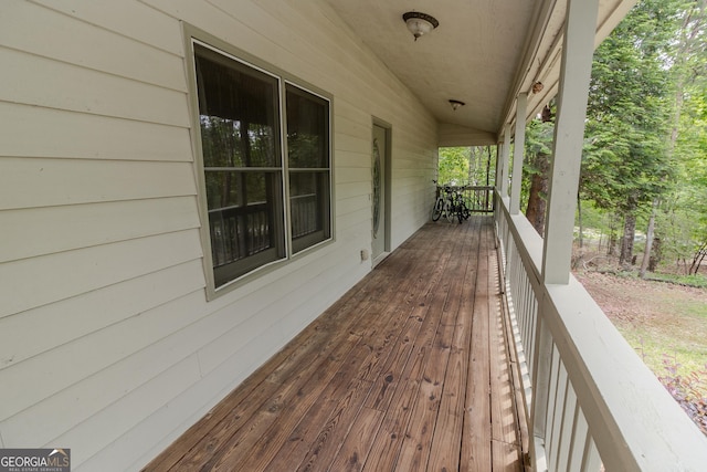 wooden terrace featuring covered porch