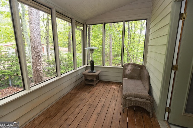 sunroom featuring vaulted ceiling and plenty of natural light
