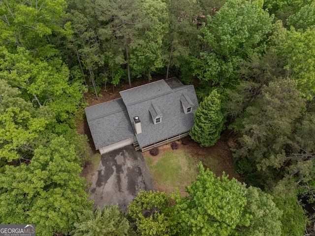 view from above of property featuring a heavily wooded area