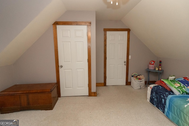 carpeted bedroom with vaulted ceiling