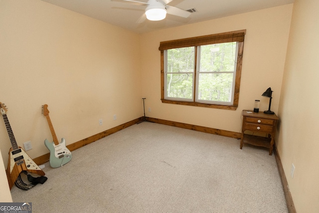 unfurnished bedroom featuring light carpet, baseboards, and a ceiling fan