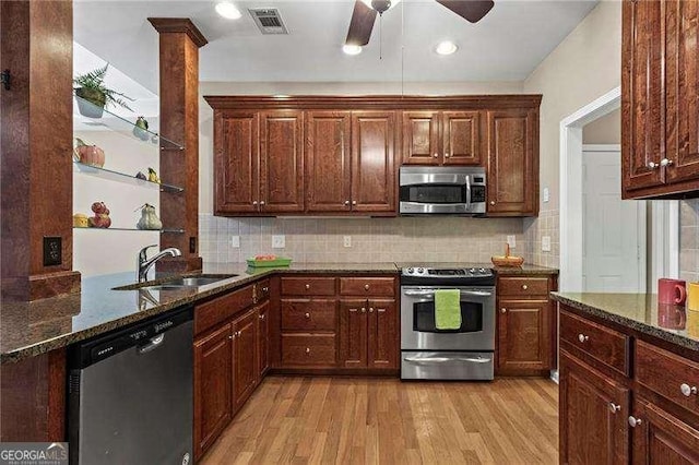 226 Hames Rd Unit 335, Woodstock, GA 30188 - kitchen featuring appliances with stainless steel finishes, light wood finished floors, dark stone countertops, backsplash, and recessed lighting