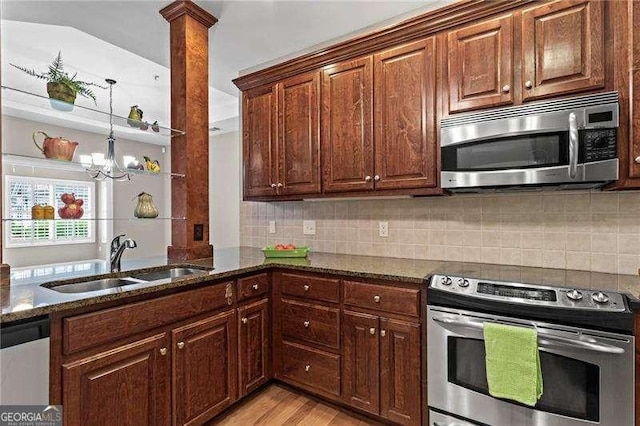 226 Hames Rd Unit 335, Woodstock, GA 30188 - kitchen with stainless steel appliances, dark stone counters, light wood-type flooring, and decorative backsplash