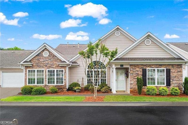 226 Hames Rd Unit 335, Woodstock, GA 30188 - view of front facade with stone siding, an attached garage, and driveway