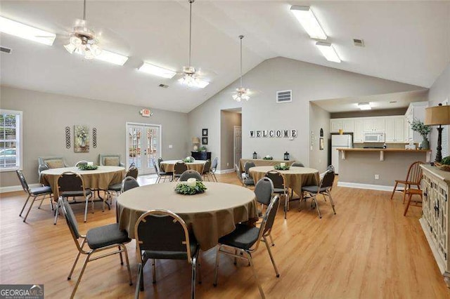 226 Hames Rd Unit 335, Woodstock, GA 30188 - dining room with light wood-style flooring, high vaulted ceiling, and a ceiling fan