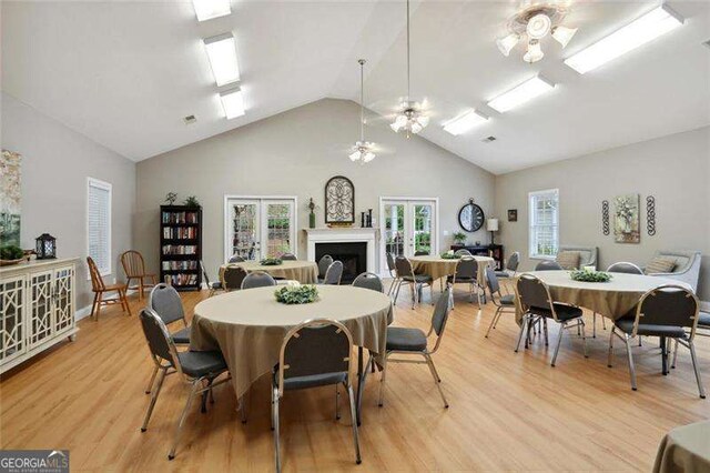 226 Hames Rd Unit 335, Woodstock, GA 30188 - dining room with a ceiling fan, light wood-style flooring, high vaulted ceiling, and french doors