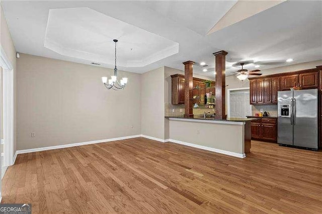 226 Hames Rd Unit 335, Woodstock, GA 30188 - kitchen with stainless steel appliances, ornate columns, wood finished floors, tasteful backsplash, and a chandelier