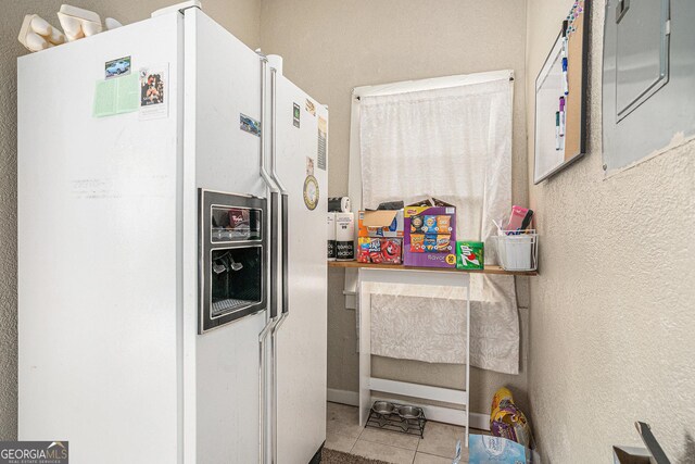 2249 Jackson Lake Rd, Mansfield, GA 30055 - kitchen with white refrigerator with ice dispenser, tile patterned flooring, and a textured wall