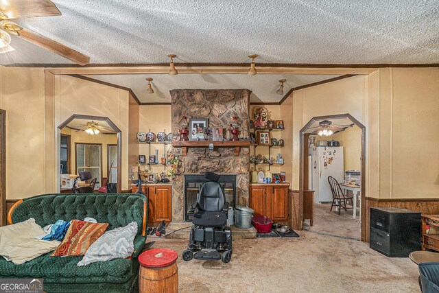 2249 Jackson Lake Rd, Mansfield, GA 30055 - carpeted living area with a ceiling fan, arched walkways, ornamental molding, and a textured ceiling