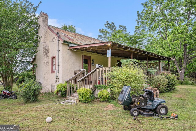 2249 Jackson Lake Rd, Mansfield, GA 30055 - view of front facade featuring stucco siding, a front yard, and a chimney