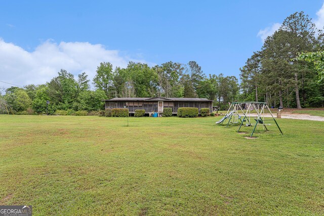 2249 Jackson Lake Rd, Mansfield, GA 30055 - view of grassy yard featuring a playground