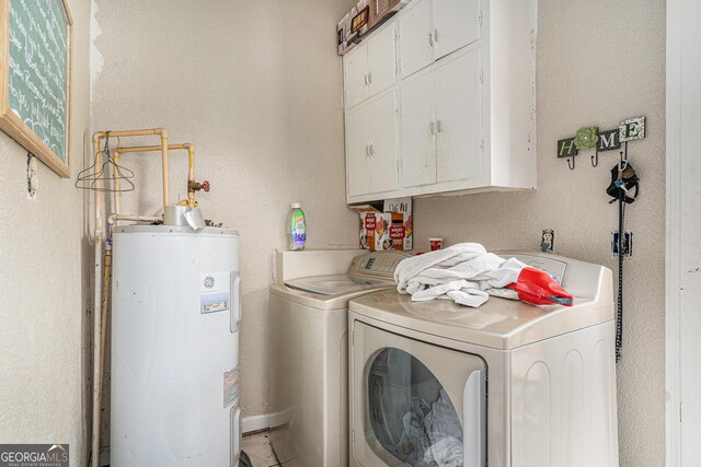 2249 Jackson Lake Rd, Mansfield, GA 30055 - washroom featuring water heater, washer and clothes dryer, and cabinet space