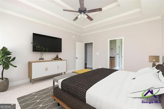 bedroom with a tray ceiling, crown molding, carpet floors, and ensuite bath