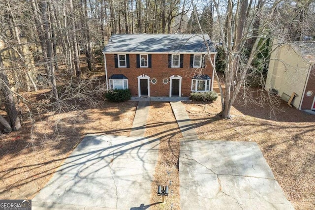 colonial-style house with brick siding