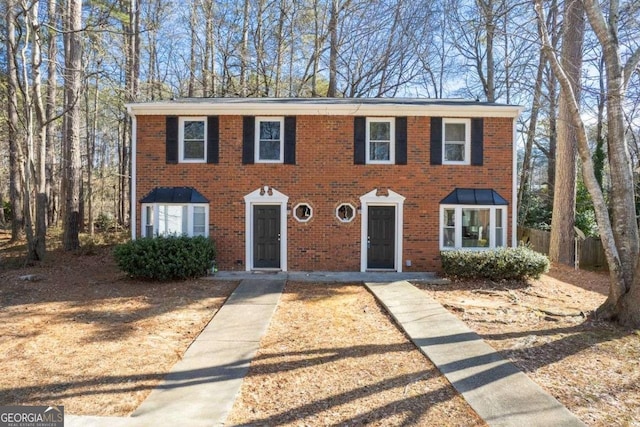 colonial-style house with brick siding