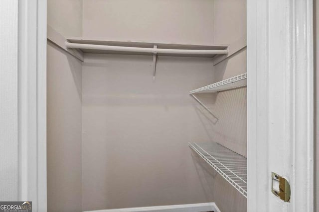 unfurnished bedroom with carpet flooring, a textured ceiling, multiple windows, and baseboards