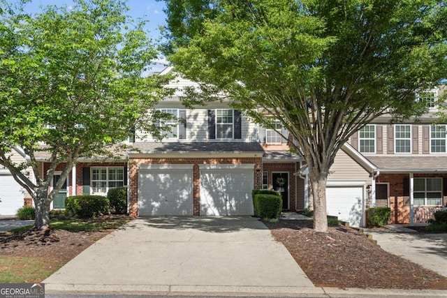 view of front of home with concrete driveway, brick siding, and a garage