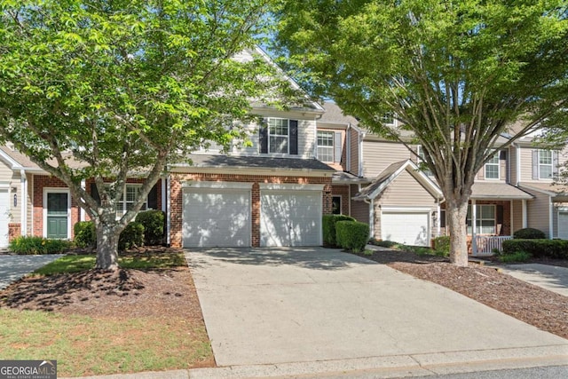 view of front of home with brick siding, concrete driveway, and an attached garage