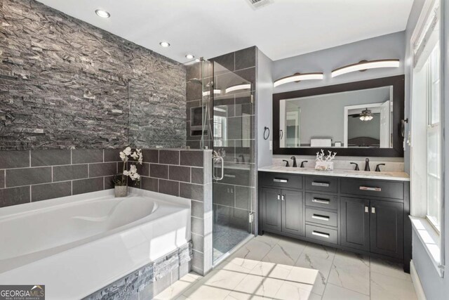 bathroom featuring double vanity, a bath, a shower stall, healthy amount of natural light, and recessed lighting