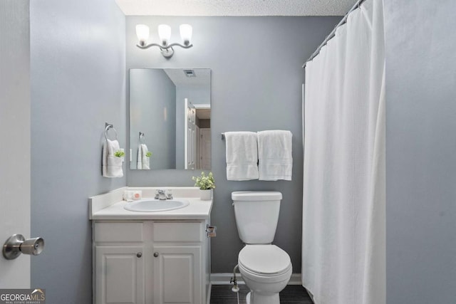 full bathroom featuring toilet and vanity