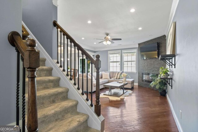 living room featuring a ceiling fan, a fireplace, stairs, baseboards, and recessed lighting