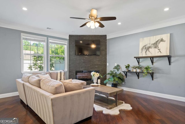 living room with ceiling fan, baseboards, a fireplace, wood finished floors, and ornamental molding