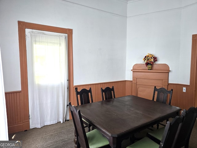 61 Calhoun St, Gibson, GA 30810 - carpeted dining room featuring a wainscoted wall and wood walls