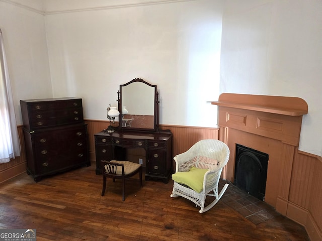 61 Calhoun St, Gibson, GA 30810 - sitting room with wainscoting, wood finished floors, a fireplace, and wooden walls