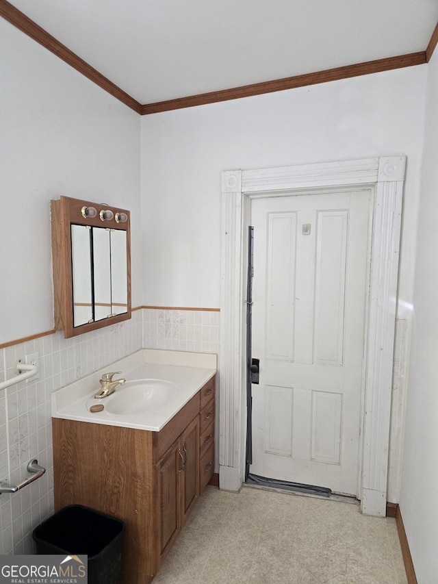 61 Calhoun St, Gibson, GA 30810 - bathroom with tile walls, crown molding, vanity, a wainscoted wall, and tile patterned floors