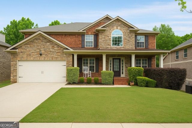 4415 Saint Andrews Crest Dr, Cumming, GA 30040 - craftsman inspired home with concrete driveway, covered porch, a front yard, stone siding, and a garage