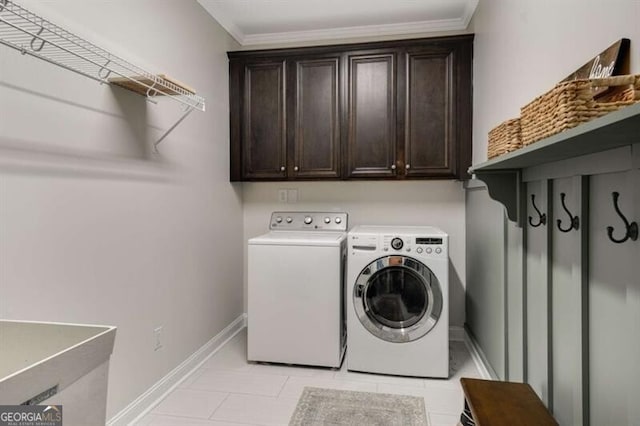 4415 Saint Andrews Crest Dr, Cumming, GA 30040 - laundry area featuring washer and clothes dryer, cabinet space, ornamental molding, and light tile patterned flooring