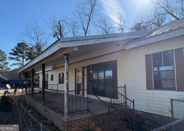 back of house featuring a porch and crawl space
