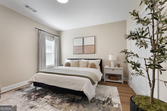 bedroom featuring light wood-style flooring and baseboards