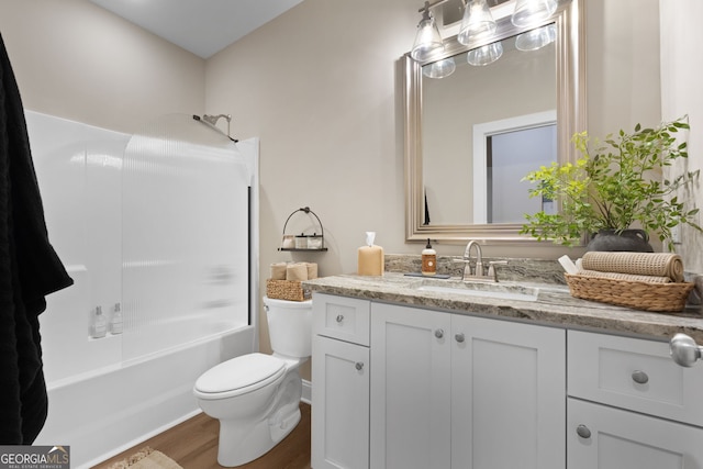 full bath featuring wood finished floors, toilet, vanity, and bathing tub / shower combination