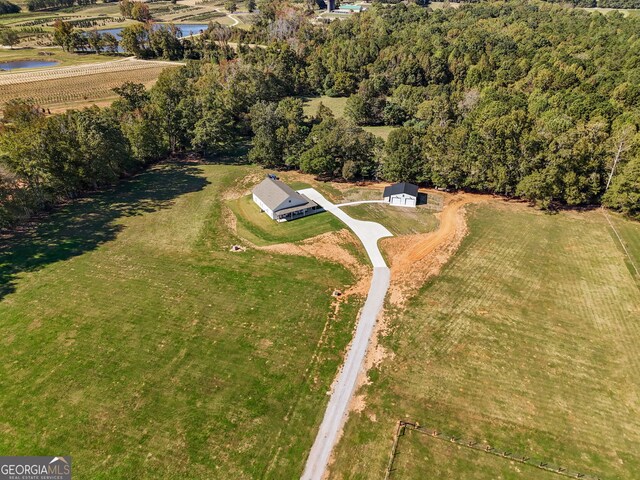 aerial view of property and surrounding area with a nearby body of water