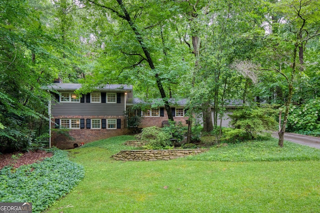 220 N Springs Ct, Sandy Springs, GA 30328 - split level home with brick siding, a front yard, and a chimney