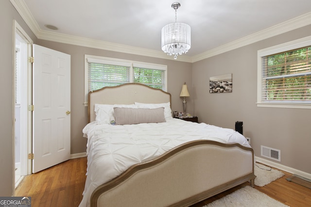 220 N Springs Ct, Sandy Springs, GA 30328 - bedroom featuring a chandelier, wood finished floors, and ornamental molding