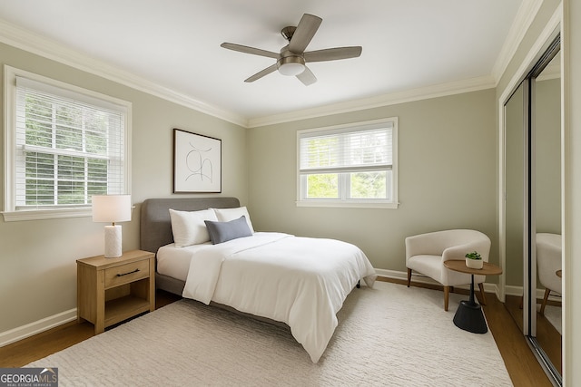 220 N Springs Ct, Sandy Springs, GA 30328 - bedroom with multiple windows, ornamental molding, wood finished floors, a closet, and a ceiling fan